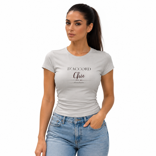 A woman wearing a light gray fitted t-shirt with the French text 'D'ACCORD Chie' printed on the chest, paired with light blue jeans, set against a plain white background.