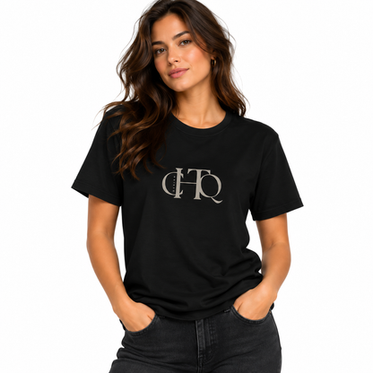 Woman wearing a black CHTQ Design graphic T-shirt with minimalist front monogram