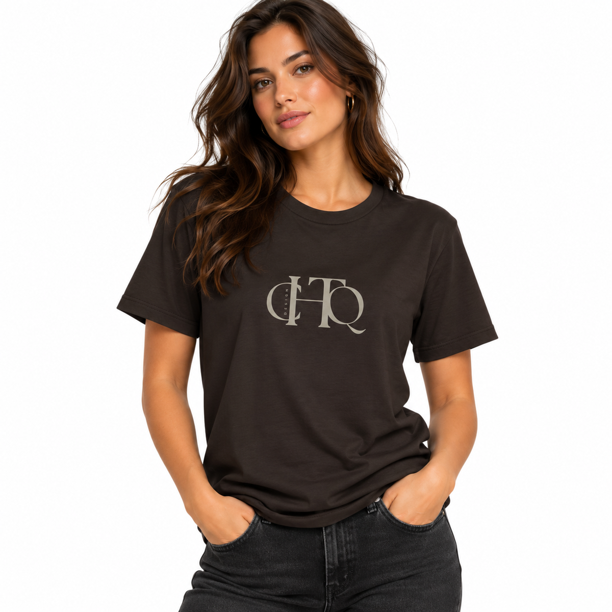 Woman wearing a dark chocolate CHTQ Design graphic T-shirt with minimalist front monogram
