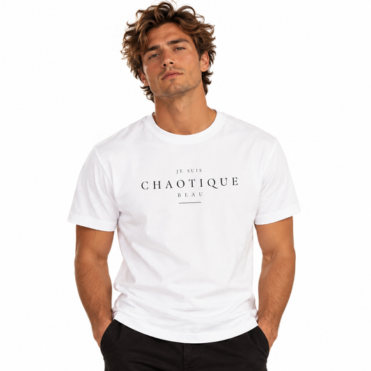 A man wearing a white crewneck t-shirt with black text reading 'JE SUIS CHAOTIQUE BEAU' on the chest, paired with black pants, against a solid white background.