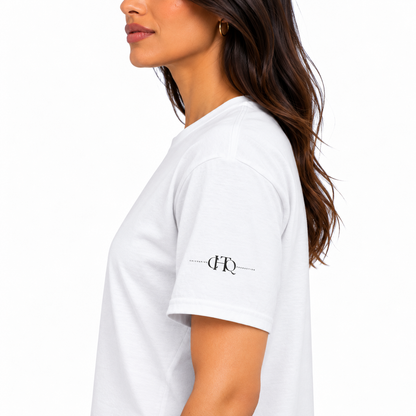 Close-up of white CHAOTIQUE graphic T-shirt sleeve featuring a small CHTQ Design logo.