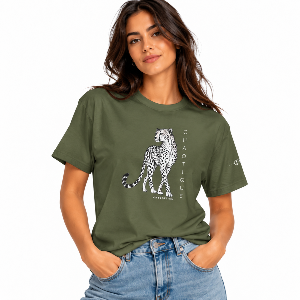 Woman wearing a military green CHAOTIQUE graphic T-shirt with hand-drawn cheetah illustration and vertical CHAOTIQUE text, styled with light blue jeans.