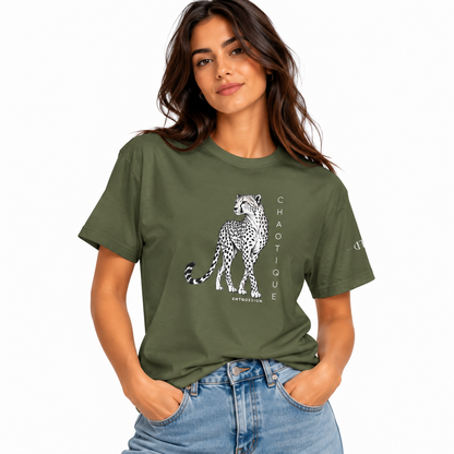 Woman wearing a military green CHAOTIQUE graphic T-shirt with hand-drawn cheetah illustration and vertical CHAOTIQUE text, styled with light blue jeans.