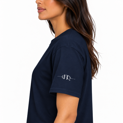 Close-up of navy CHAOTIQUE graphic T-shirt sleeve featuring a small CHTQ Design logo.