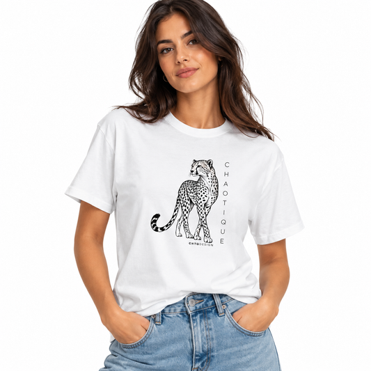 Woman wearing a white CHAOTIQUE graphic T-shirt with hand-drawn cheetah illustration and vertical CHAOTIQUE text, styled with light blue jeans.