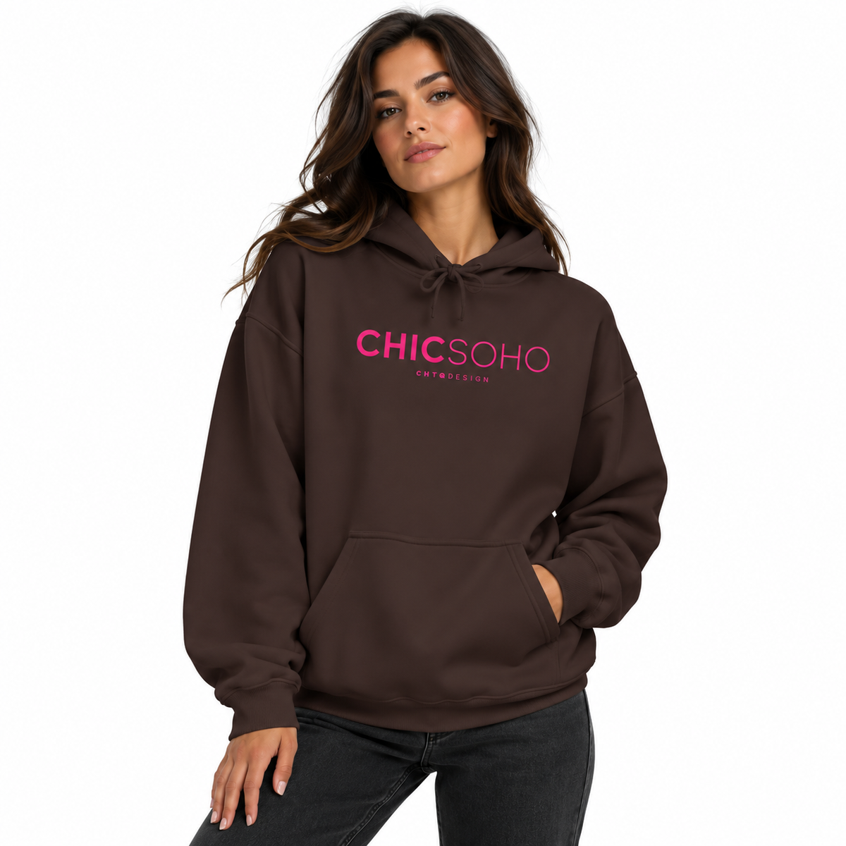 A woman wearing a dark brown pullover hoodie with 'CHICSOHO' printed in pink across the chest, paired with dark gray jeans, set against a plain white background.