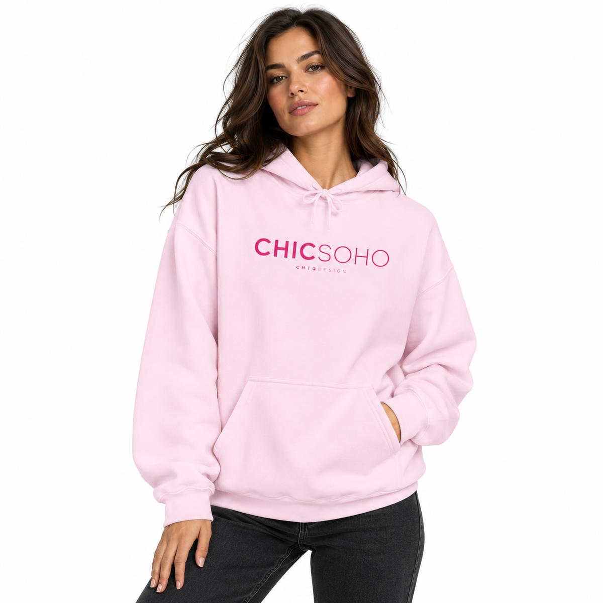 A woman modeling a light pink pullover hoodie with 'CHICSOHO' printed in pink across the chest, paired with black jeans against a plain white background.