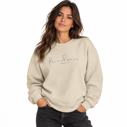 PRIMADONNA by CHTQ Design sand crewneck sweatshirt with delicate gray handwritten logo on the chest, front view on white background.