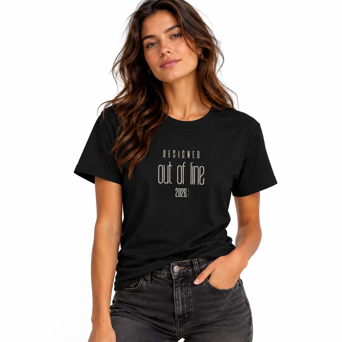 Female model wearing a black Designed Out of Line 2026 graphic T-shirt with dark washed jeans against a white studio background.