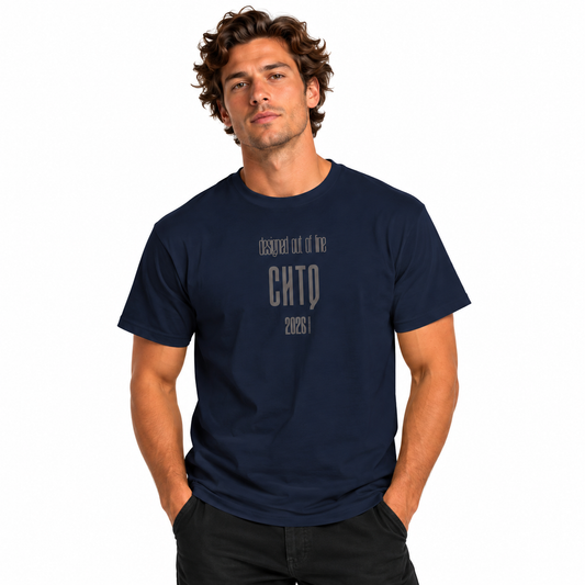 Male model wearing a navy blue Designed Out of Line CHTQ Graphic T-Shirt with gray typography, paired with black trousers against a white studio background.