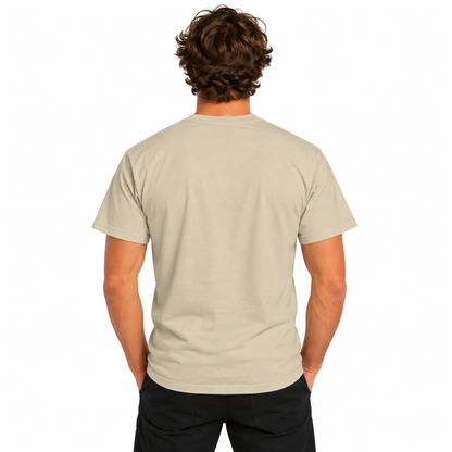 Back view of a male model wearing a sand-colored Designed Out of Line CHTQ Graphic T-Shirt with a plain, unprinted back and black trousers against a white studio background.