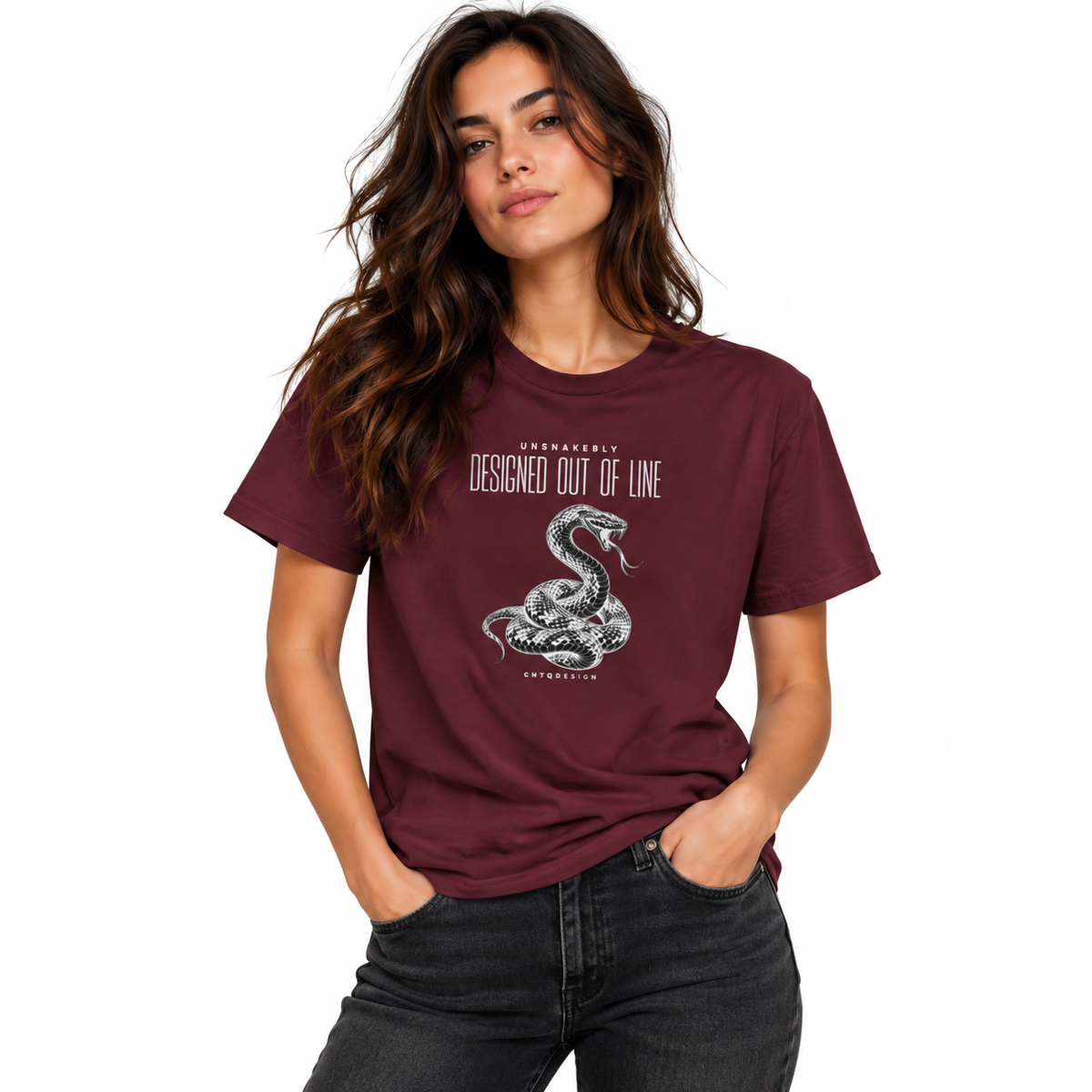 Female model wearing a burgundy UNSNAKEBLY snake graphic T-shirt with dark jeans against a white studio background.