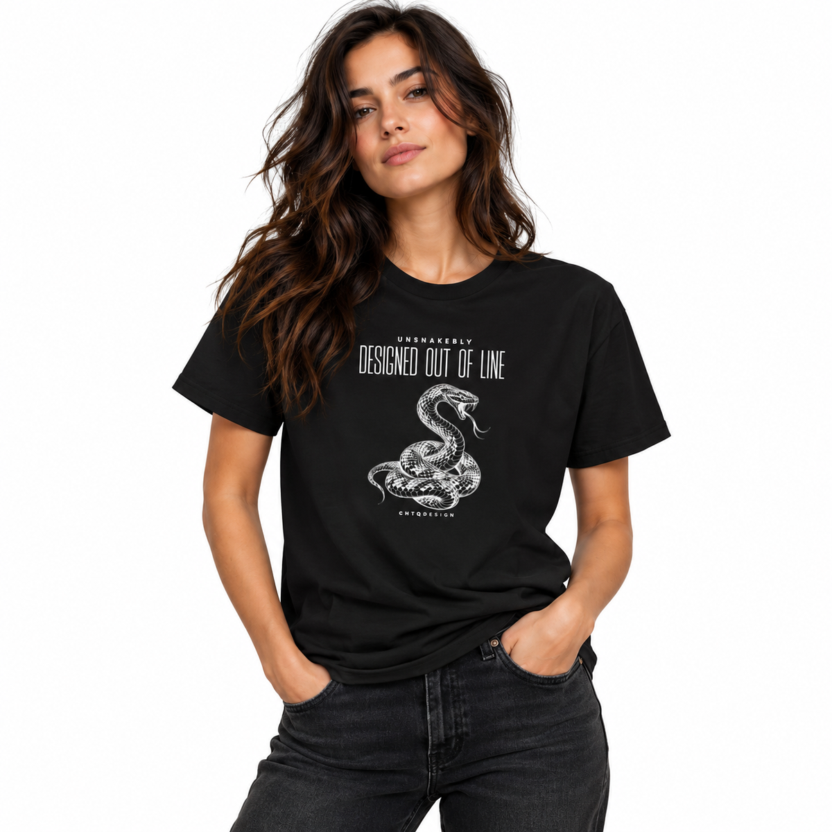 Female model wearing a black UNSNAKEBLY snake graphic T-shirt with dark jeans against a white studio background.