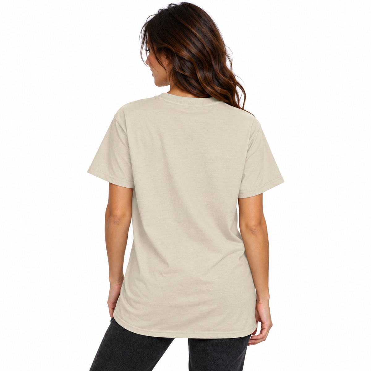 Back view of a female model wearing a cream beige UNSNAKEBLY T-shirt with a long relaxed fit and dark jeans.