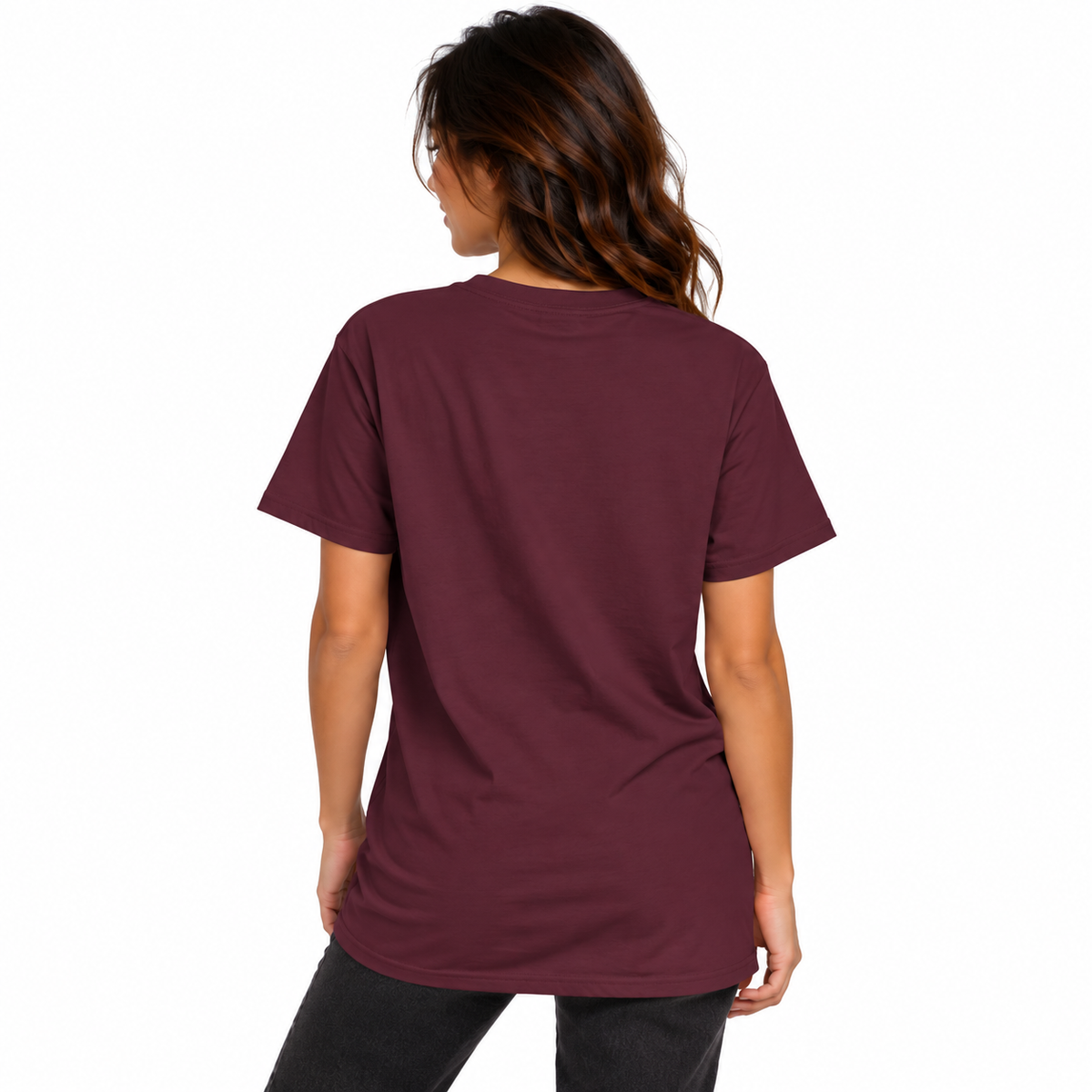 Back view of a female model wearing a burgundy UNSNAKEBLY T-shirt with a long relaxed fit and dark jeans.