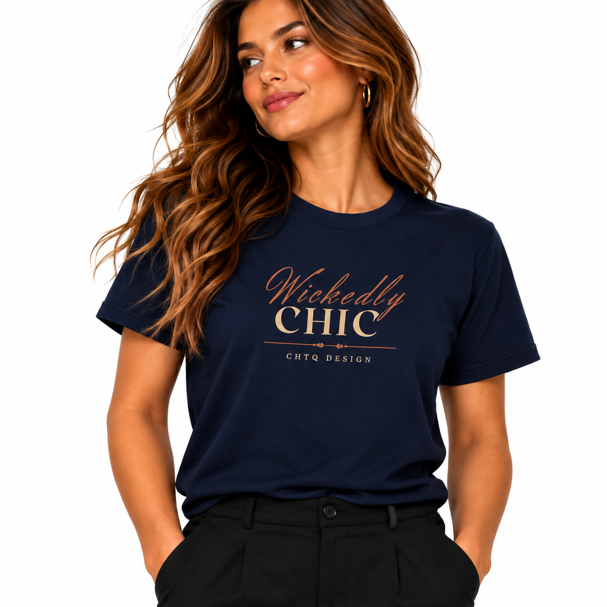 A woman wearing a navy blue short-sleeve graphic T-shirt with 'Wickedly CHIC' printed in metallic rose-gold lettering on the chest, paired with black pants against a plain white background.