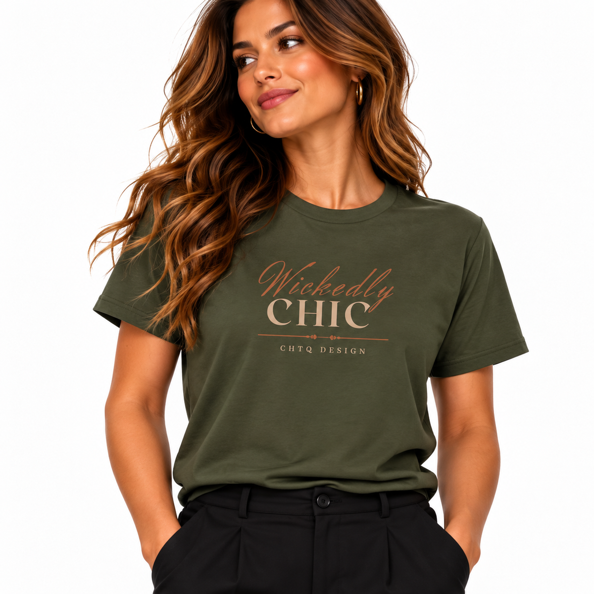 A woman wearing an olive green graphic t-shirt with 'Wickedly CHIC' printed in rose gold lettering on the chest, paired with black pants, against a plain white background.
