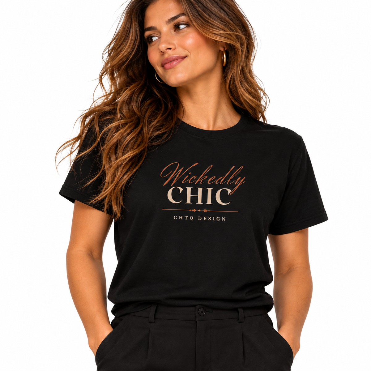 A woman wearing a black short-sleeve graphic T-shirt with 'Wickedly CHIC' printed in metallic rose-gold lettering on the chest, paired with black pants against a plain white background.