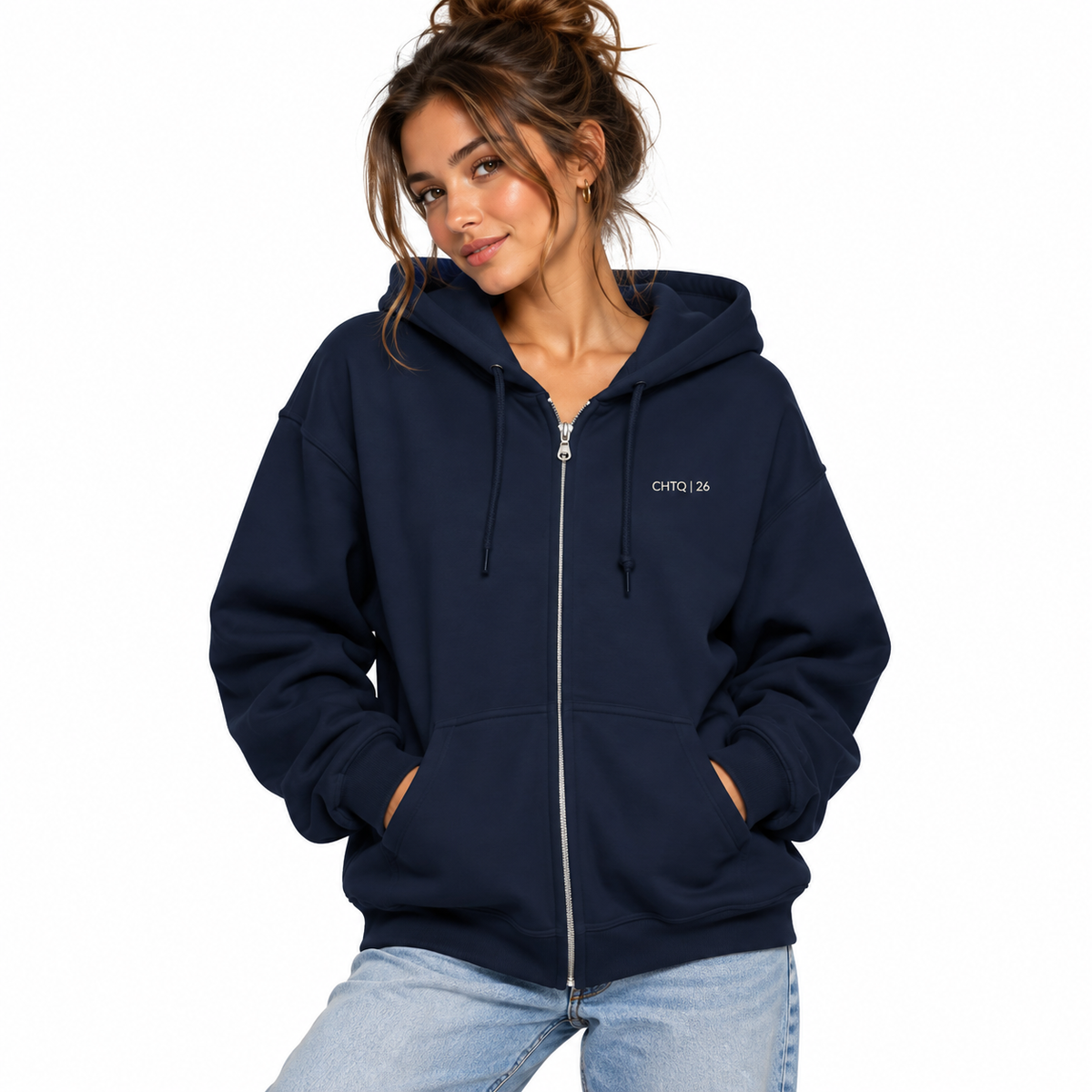 A woman wearing a navy blue zip-up hoodie with a small white 'CHTQ 26' logo on the left chest, paired with light blue jeans, set against a plain white background.