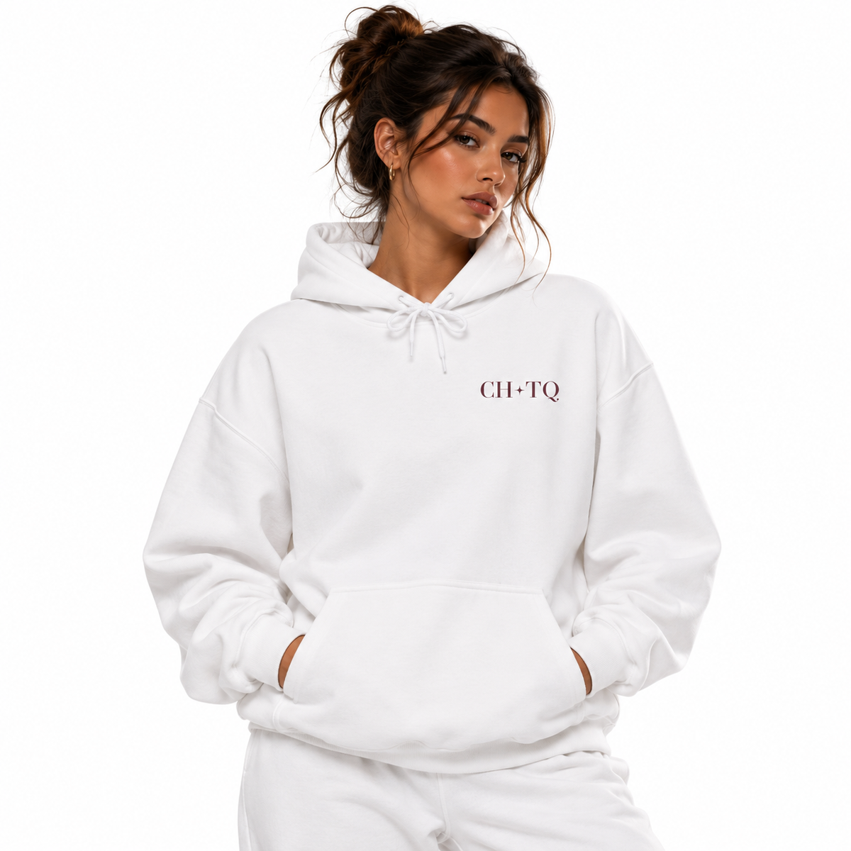A woman wearing a white pullover hoodie with 'CH-TQ' printed in dark red on the left chest, paired with matching white sweatpants, against a solid white background.