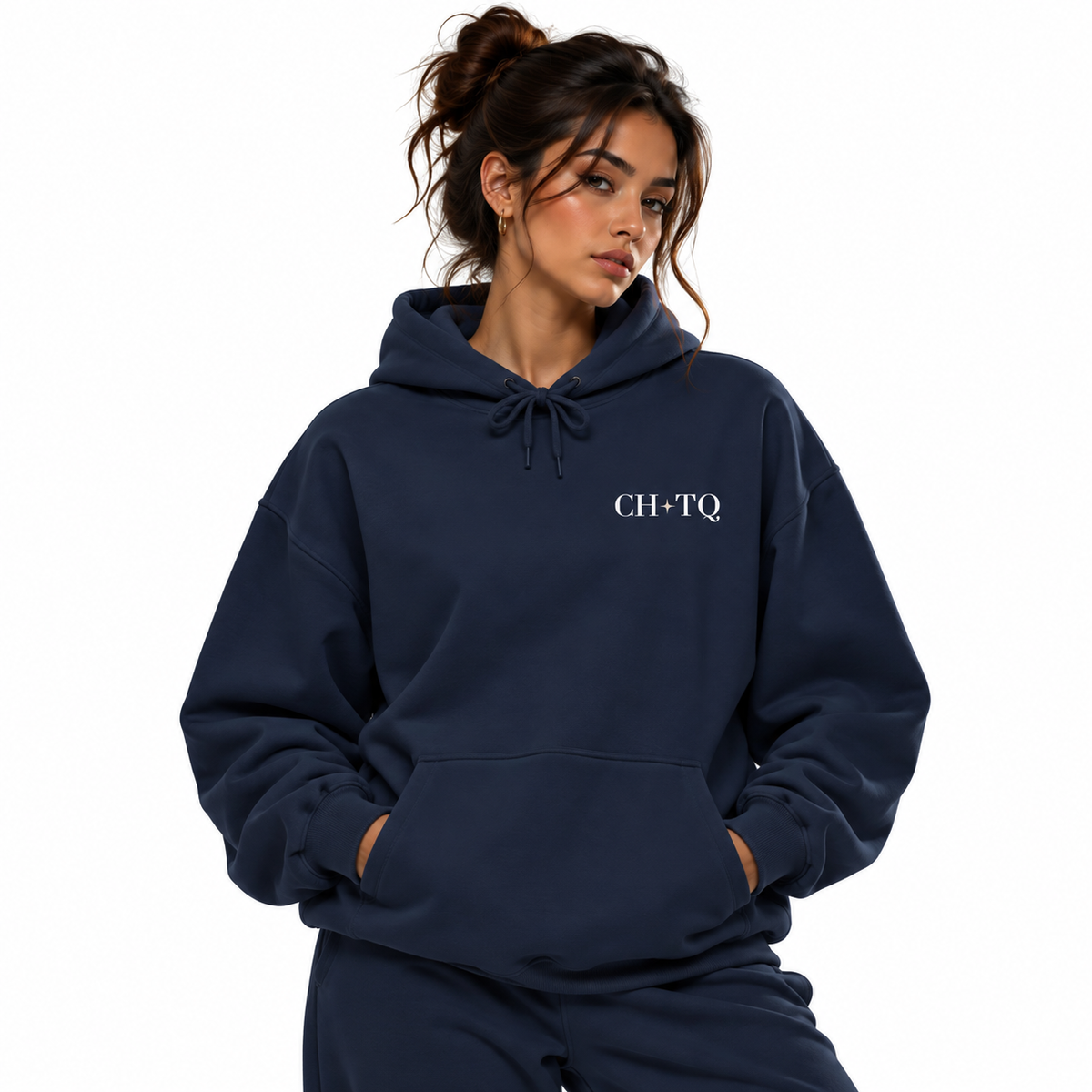 A woman wearing a navy blue pullover hoodie with 'CH+TQ' printed in white on the left chest, paired with matching navy sweatpants, set against a plain white background.