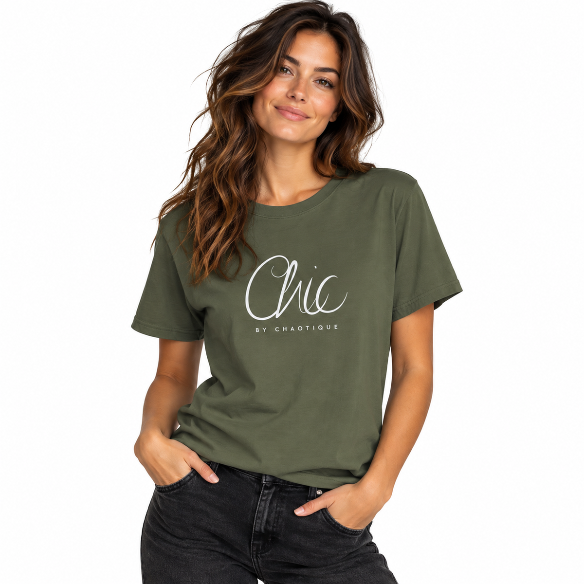 Woman wearing a military green Chic by Chaotique graphic T-shirt with black jeans against a white studio background.
