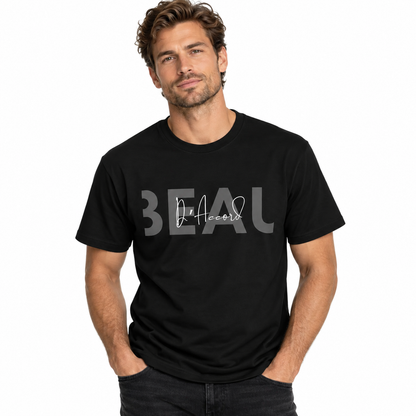 A man wearing a black short-sleeve t-shirt with a gray graphic print on the front that reads 'BEAU' with 'DAccord' in script, posed against a solid white background.
