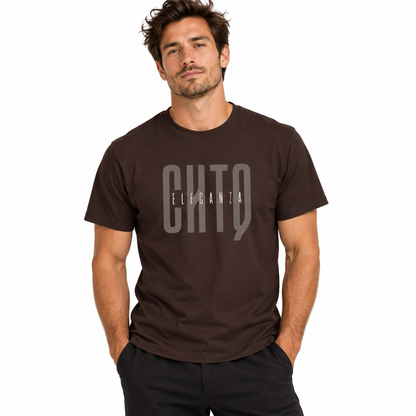 A man wearing a dark brown crewneck t-shirt with a gray graphic print that reads 'CHTQ ELEGANZA' on the chest, posed against a solid white background.