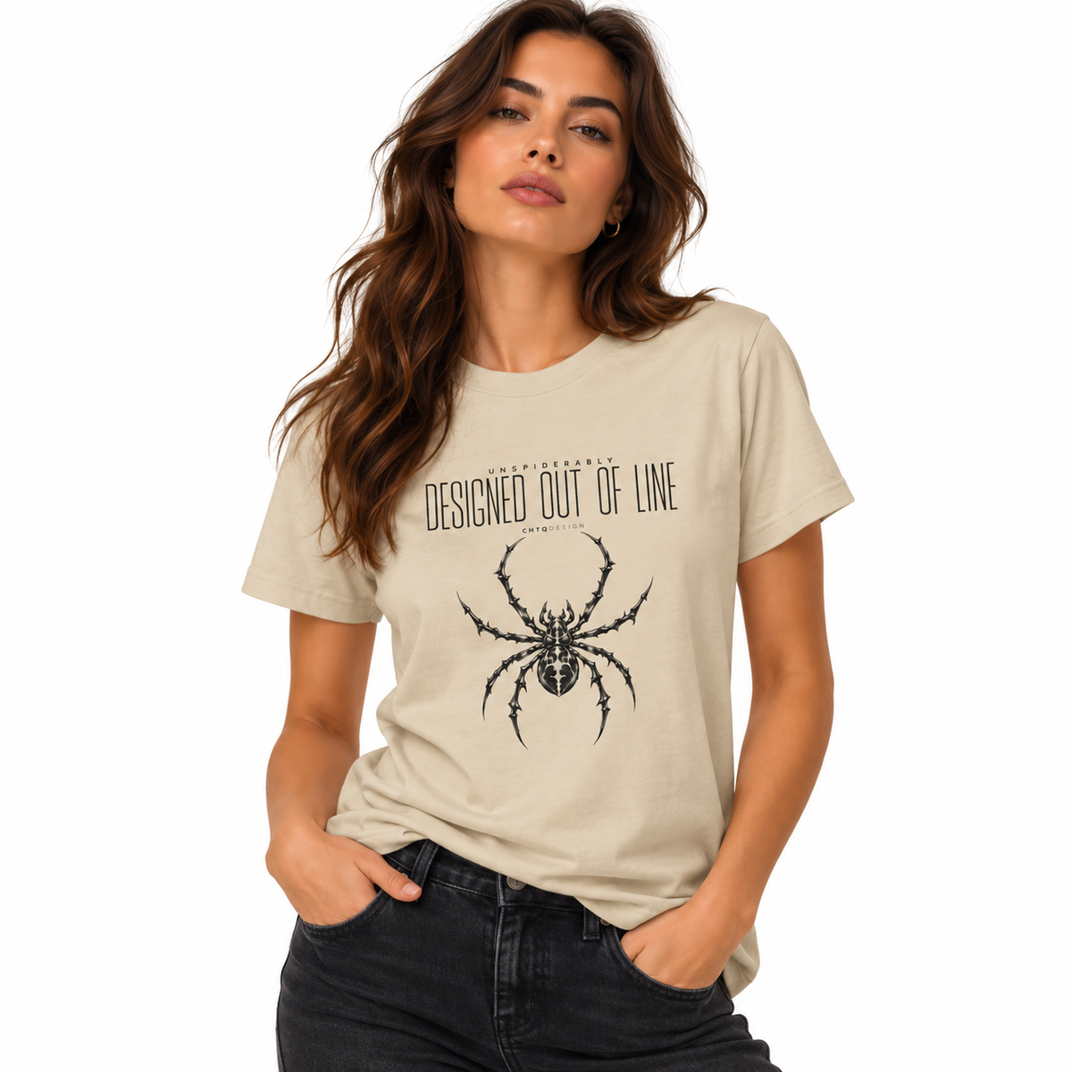 Woman wearing a cream UNSPIDERABLY Designed Out of Line spider graphic T-shirt with black jeans against a white studio background