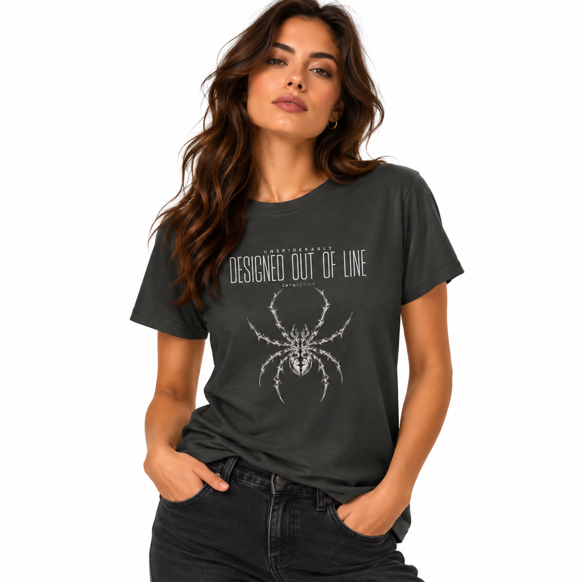 Woman wearing a charcoal gray UNSPIDERABLY Designed Out of Line spider graphic T-shirt with black jeans against a white studio background