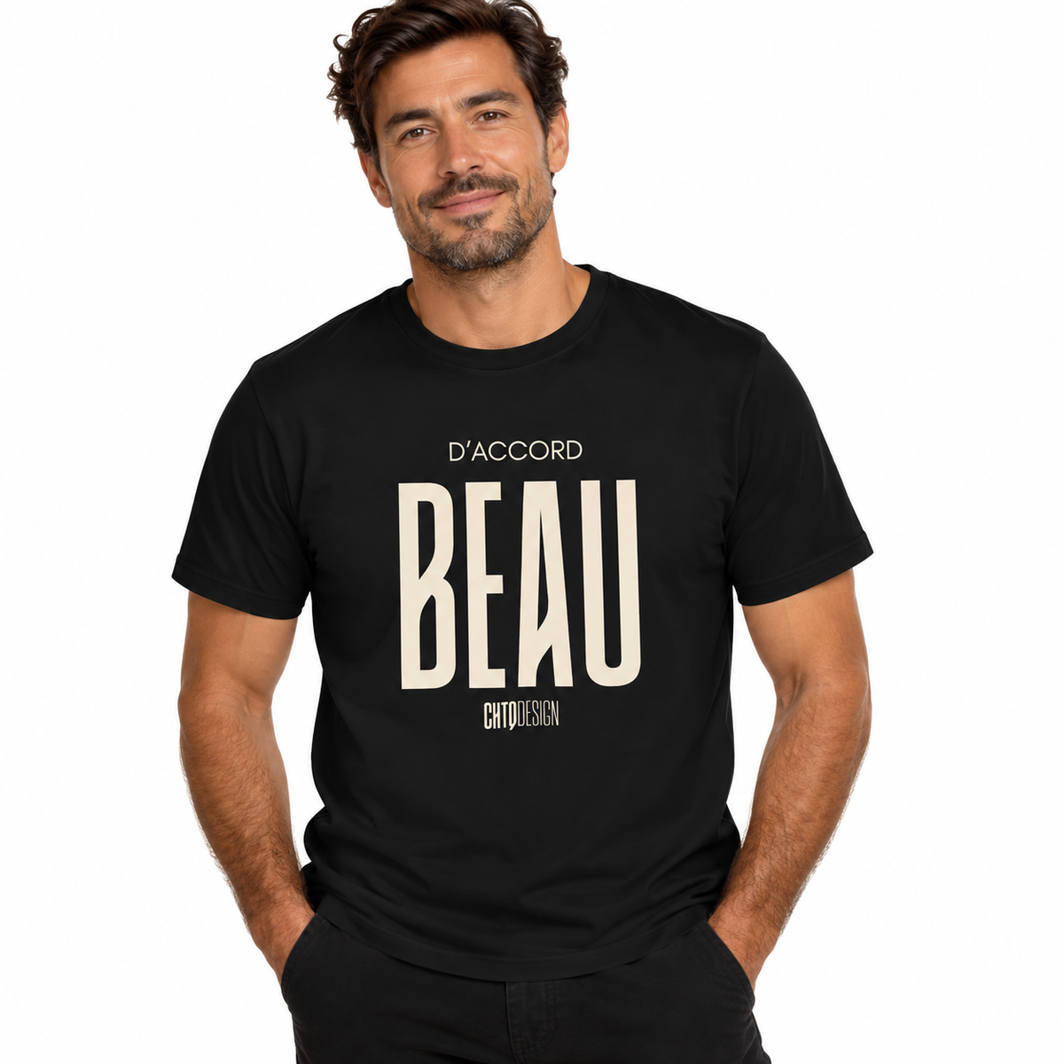 Male model wearing a black D’ACCORD BEAU Graphic T-Shirt by CHTQ Design with cream lettering, black trousers and a white studio background.