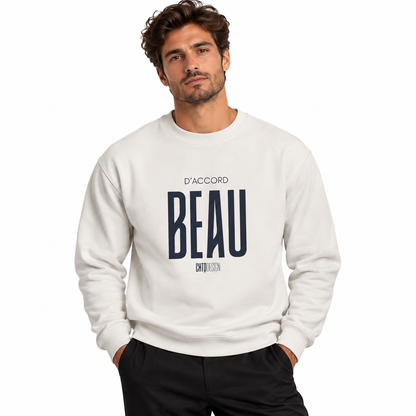 Male model wearing a white D’Accord BEAU graphic crewneck sweatshirt with black trousers against a white studio background.
