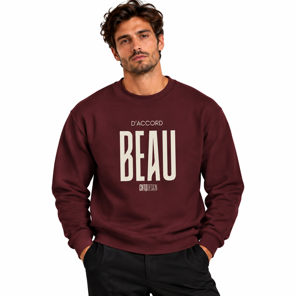 A man wearing a maroon crewneck sweatshirt with 'BEAU D'ACCORD' printed in cream on the front, paired with black pants, set against a plain white background.