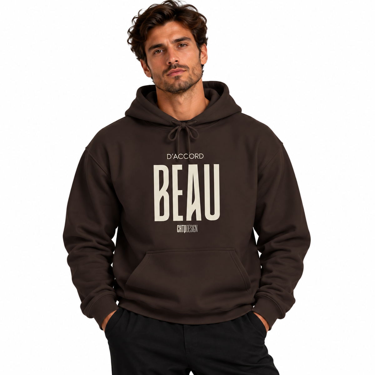 A man wearing a dark brown pullover hoodie with a large cream-colored graphic print on the front that reads 'D'ACCORD BEAU', posed against a solid white background.