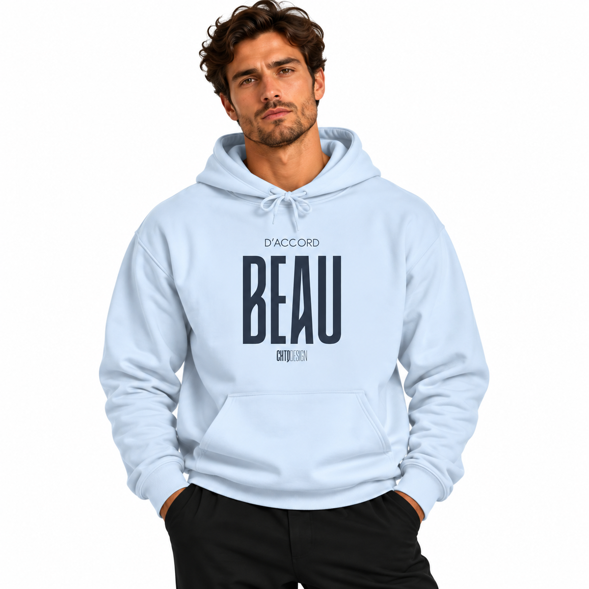 A man wearing a light blue pullover hoodie with 'D'ACCORD BEAU' printed in dark navy on the chest, paired with black pants, against a plain white background.