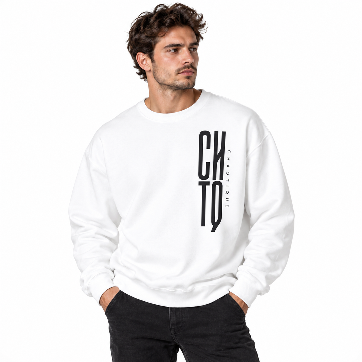 Male model wearing a white CHTQ CHAOTIQUE men's crewneck sweatshirt with vertical CHTQ graphic and CHAOTIQUE lettering, front view on a white studio background.