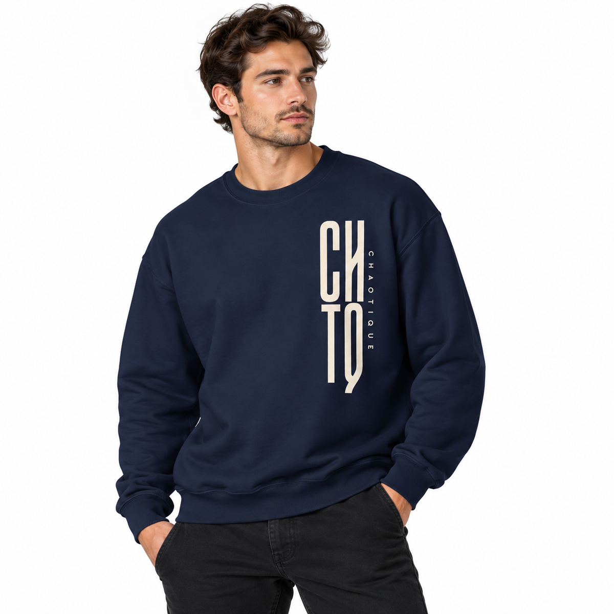Male model wearing a navy CHTQ CHAOTIQUE men's crewneck sweatshirt with vertical CHTQ graphic and CHAOTIQUE lettering, front view on a white studio background.