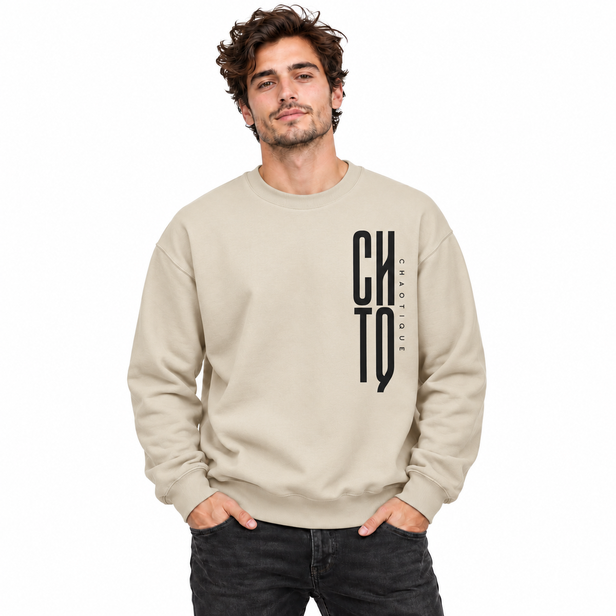 Male model wearing a beige CHTQ CHAOTIQUE men's crewneck sweatshirt with vertical CHTQ graphic and CHAOTIQUE lettering, front view on a white studio background.