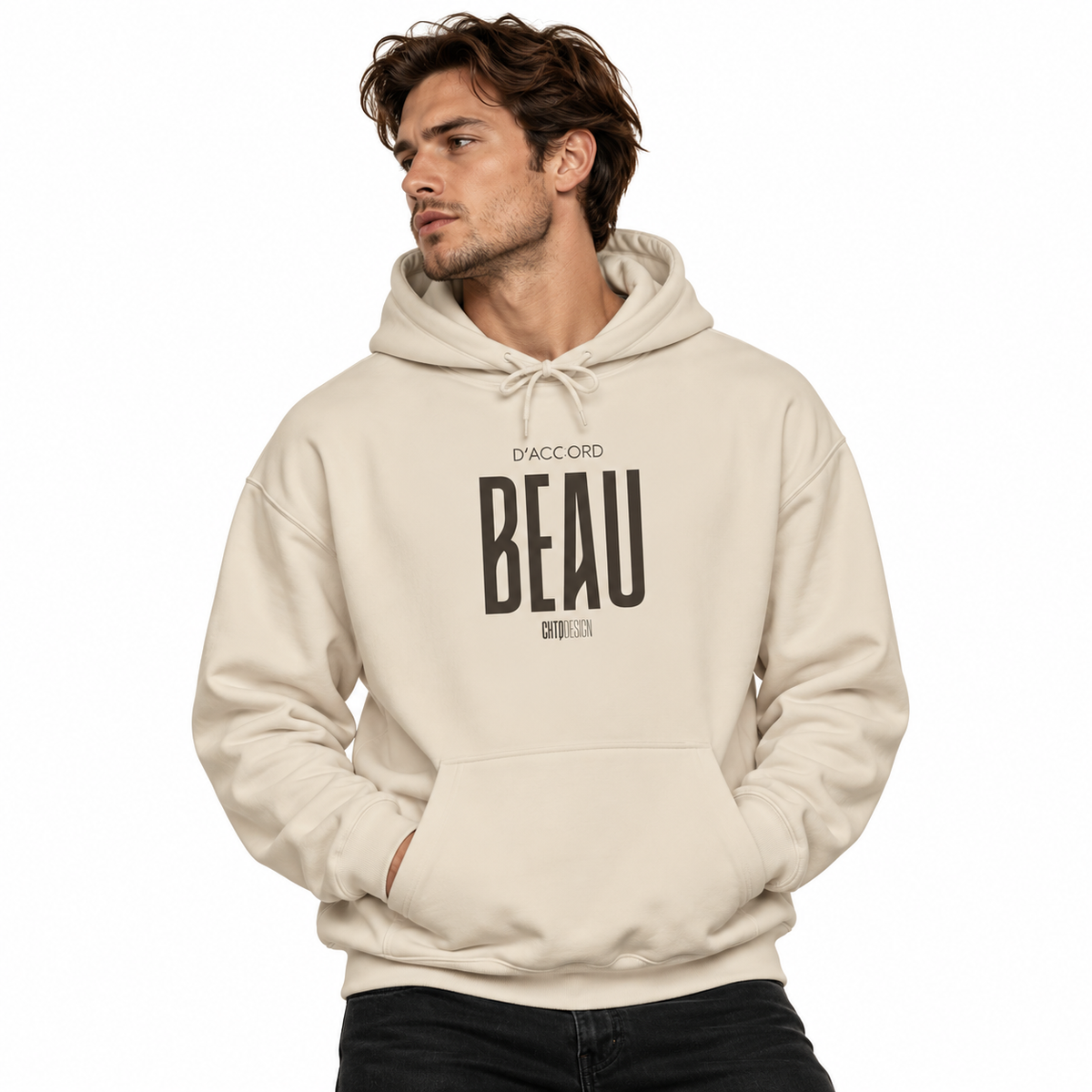 A man wearing a beige pullover hoodie with a black graphic print on the front that reads 'D'ACCORD BEAU', posed against a solid white background.