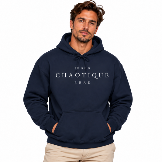Male model wearing a navy blue JE SUIS CHAOTIQUE BEAU hoodie with beige trousers against a white studio background.
