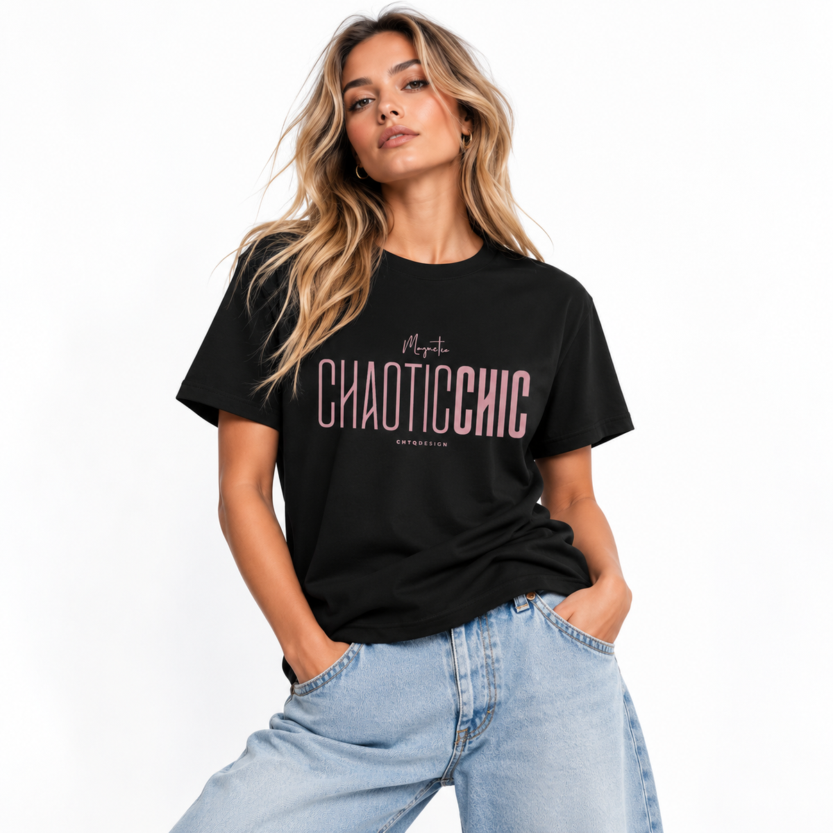 Blonde woman wearing a black Magnetic CHAOTICCHIC graphic T-shirt with dusty pink lettering and relaxed light blue jeans in a white studio.