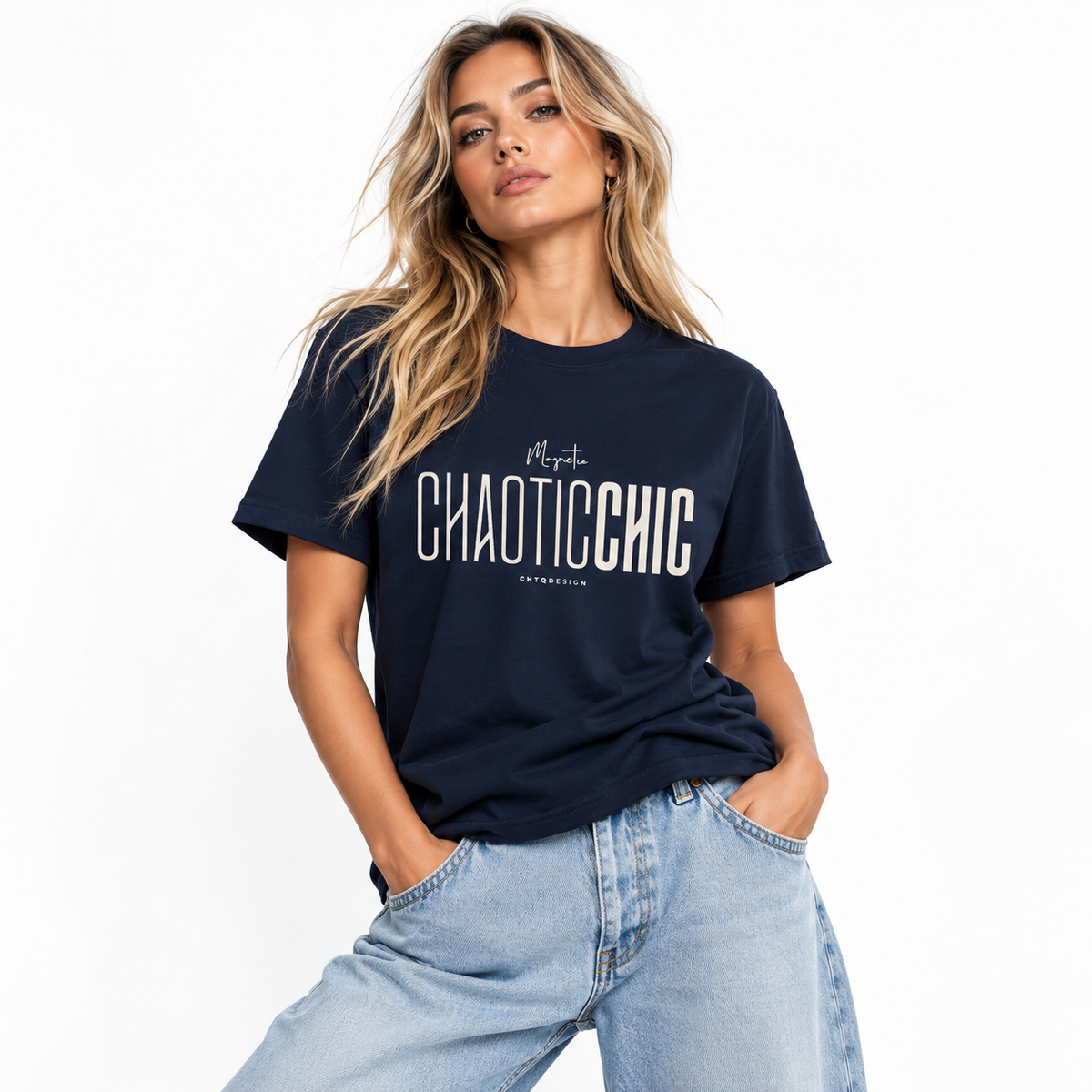 Blonde woman modeling a navy Magnetic CHAOTICCHIC graphic T-shirt with cream lettering and relaxed light blue jeans against a white studio background.