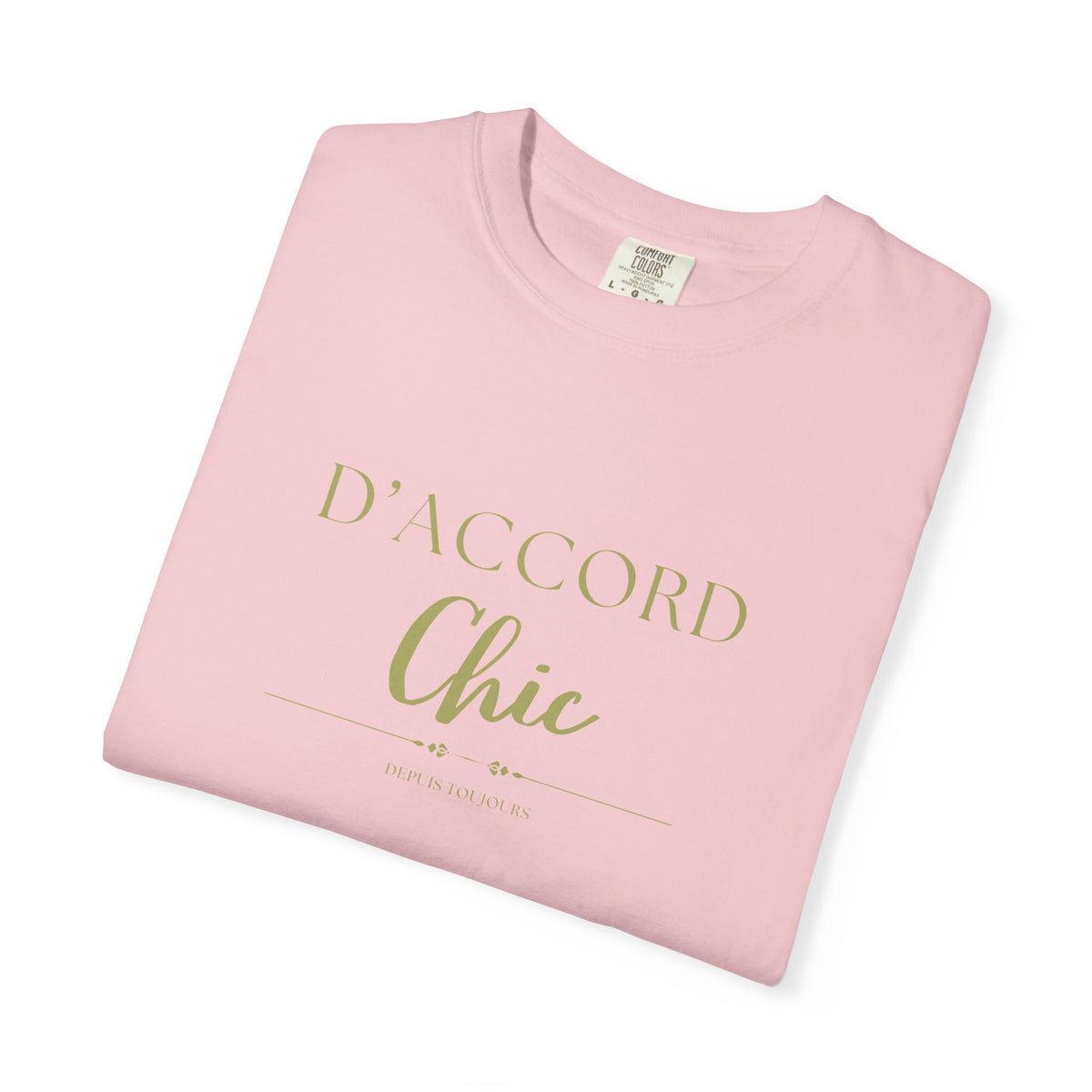 A folded light pink t-shirt with 'D'ACCORD Chic' printed in gold lettering on the front, displayed on a clean white background.