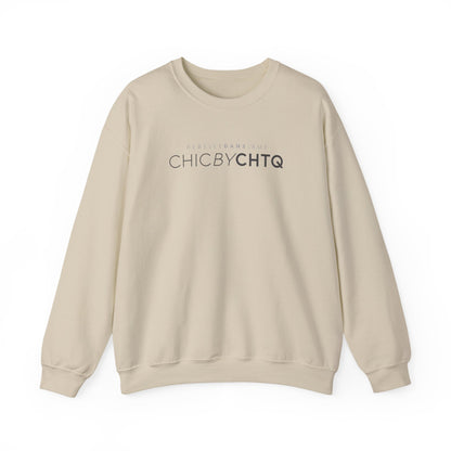 A sand color crewneck sweatshirt with text reading “CHIC BY CHTQ” and “REBELLE DANS L’ÂME” printed across the chest.