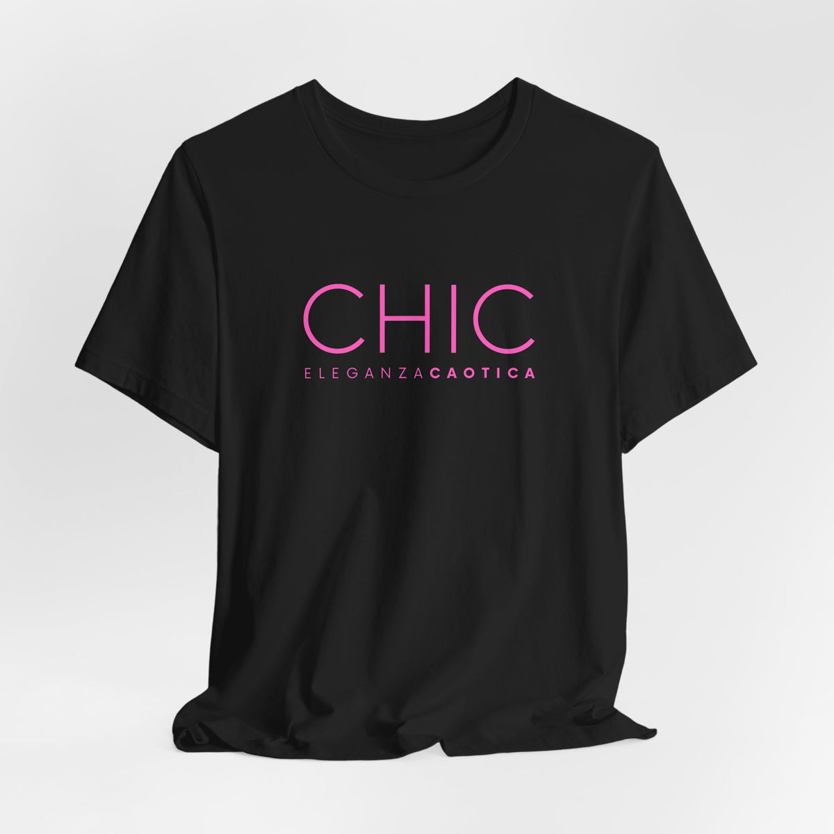 Black graphic T-shirt with pink 'CHIC ELEGANZA CAOTICA' typography on a neutral gray studio background.