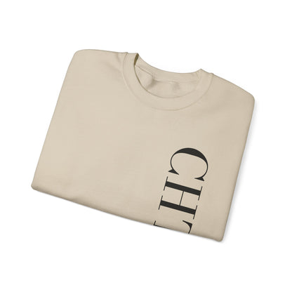 A folded beige crewneck sweatshirt with a vertical black CHTQ DESIGN graphic on the front, displayed against a clean white background.