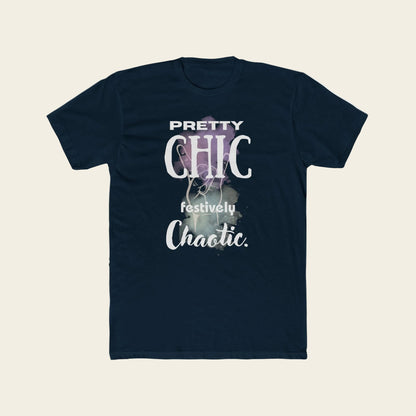 A navy blue short-sleeve t-shirt with a graphic print on the front that reads 'PRETTY CHIC festively Chaotic.' in white and light purple text over a smoky abstract background, displayed on a solid white background.