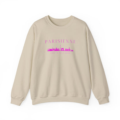 A beige crewneck sweatshirt with a bright pink “PARISIENNE” graphic, Paris skyline design, and “CHIC À MA FAÇON” text on the chest, displayed against a clean white background.