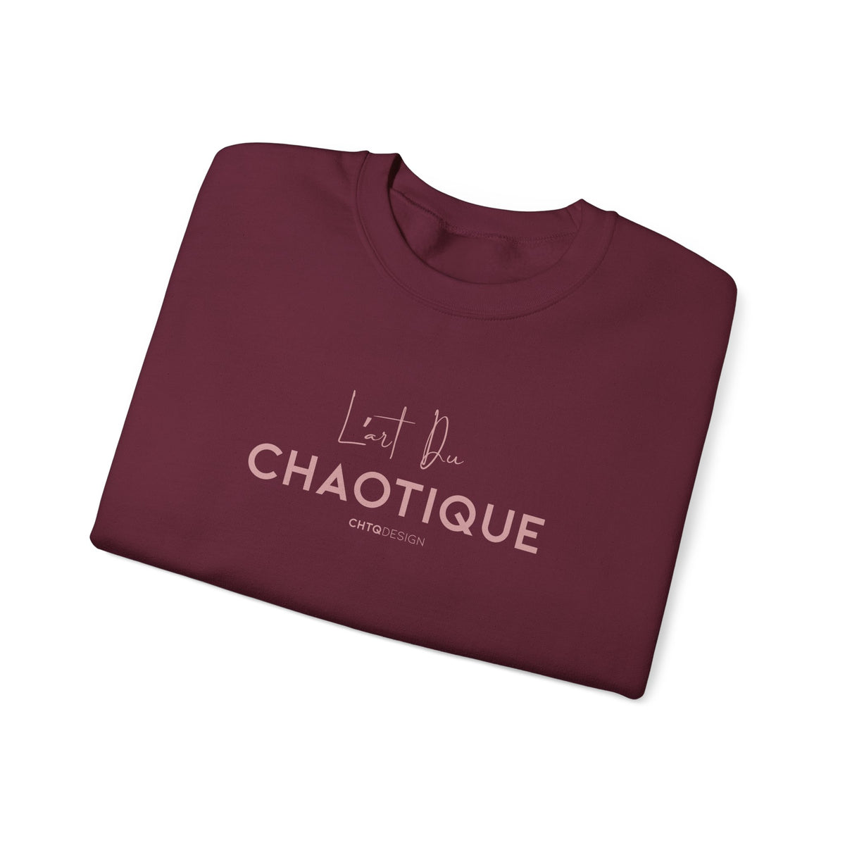 Folded maroon L’ART DU CHAOTIQUE crewneck sweatshirt from back, with minimalist front rose gold typography in front, displayed against a clean white background.