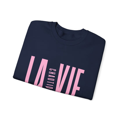 Folded navy LA VIE CHAOTIQUE sweatshirt showing light pink front graphic